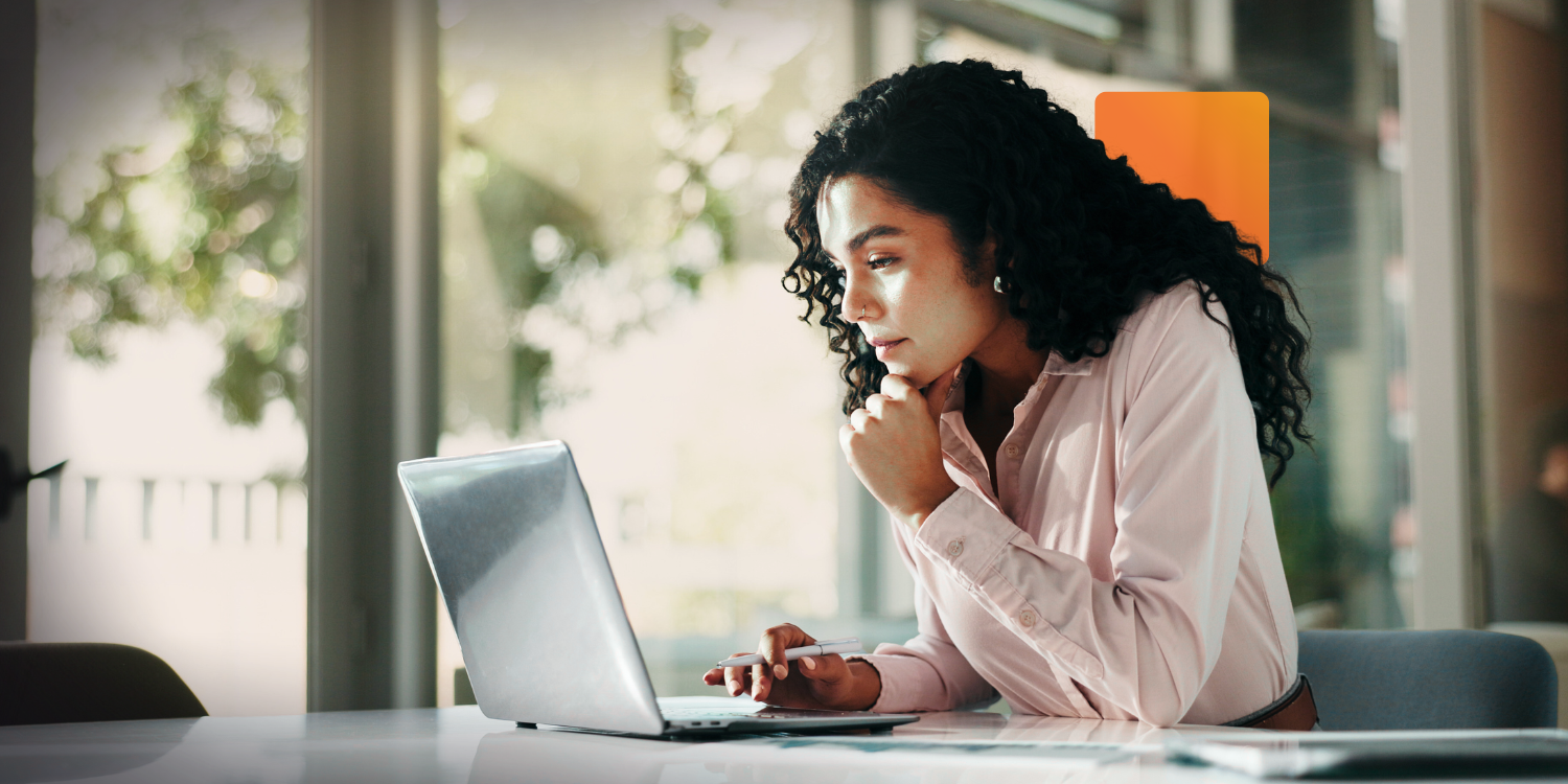 IT leader reviewing service tickets on a laptop in a modern office, reflecting Canadian ITSM software use in mid-sized organizations.